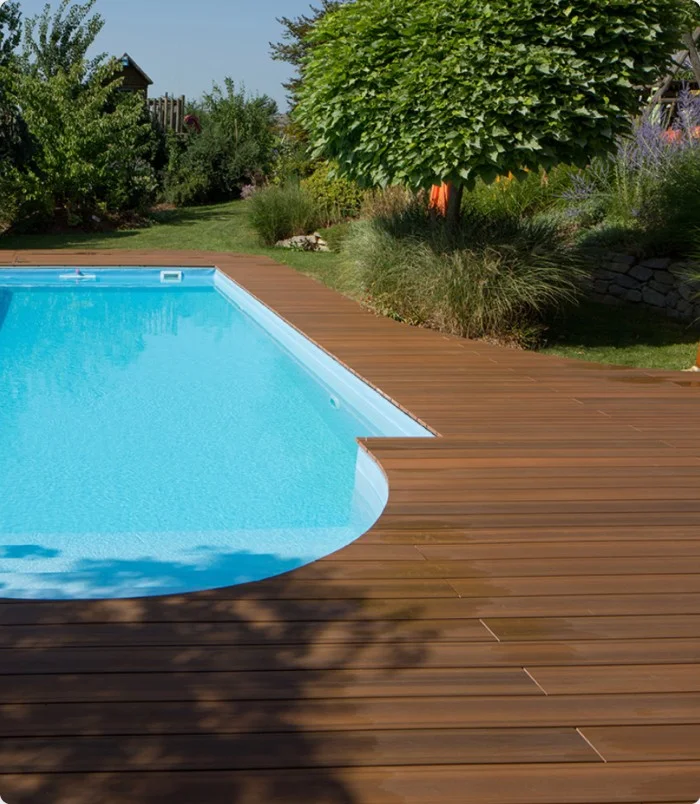 NewTechWood composite pool deck in a landscaped backyard